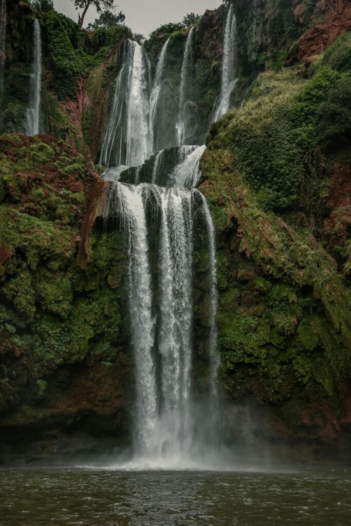 Stunning view of Ouzoud Falls cascading through lush greenery in Béni Mellal-Khénifra, Morocco.