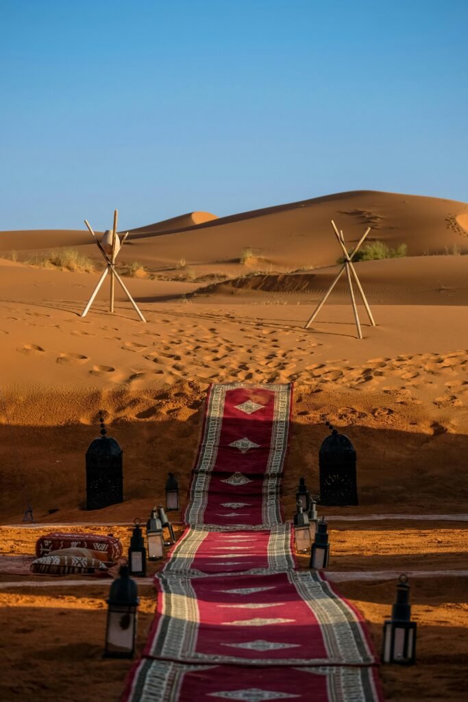 Explore the stunning sunset in Merzouga, Morocco with a vibrant pathway through the dunes.