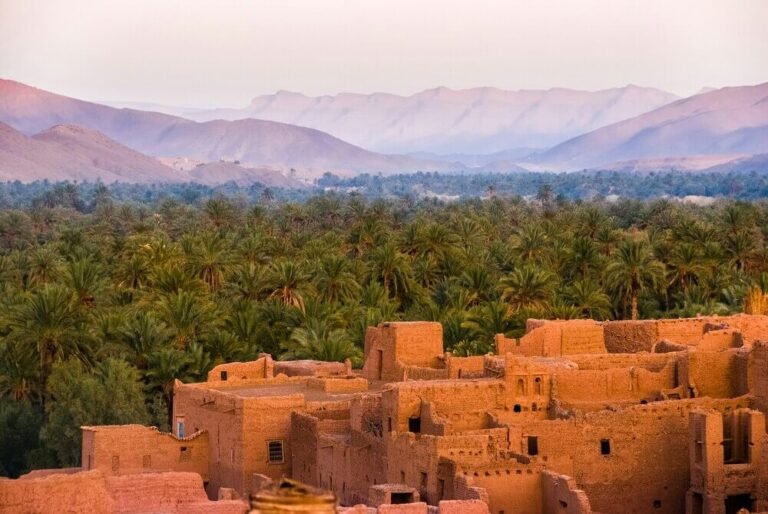Moroccan Kasbah with palm grove and Atlas Mountains landscape