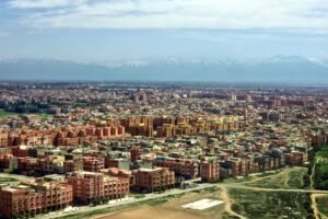 Aerial view of Marrakech cityscape with the Atlas Mountains in the background