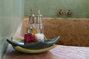 Traditional oils and soaps in a Moroccan hammam, set against zellige tilework