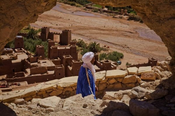 Ancient Ait Ben Haddou kasbah in Morocco surrounded by desert landscapes and Atlas Mountains