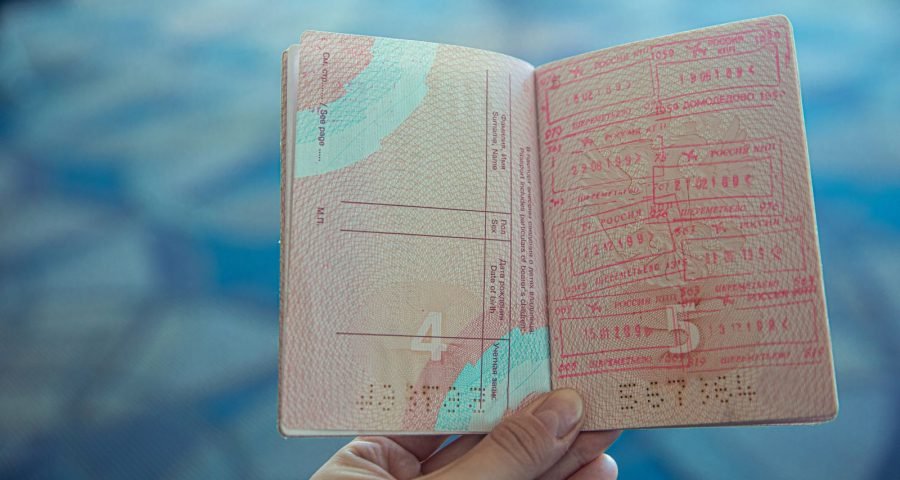 A passport with entry stamps, held ready for international travel