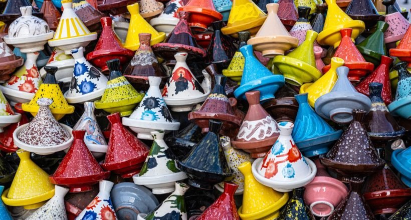 Colorful traditional tagine pots on display in a Marrakesh market