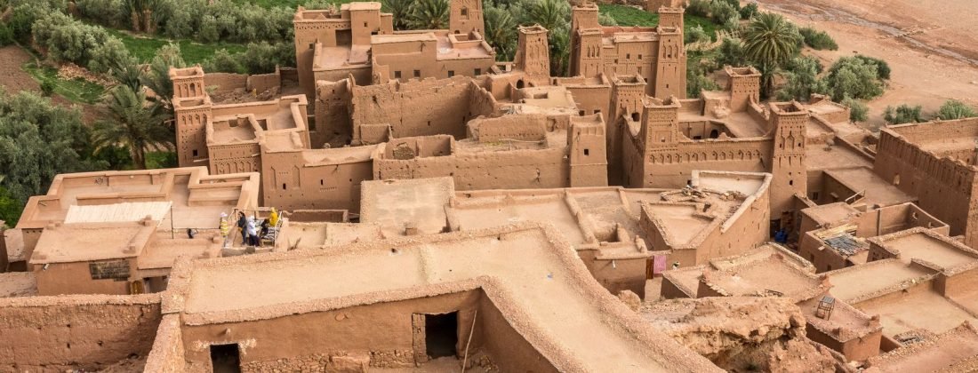 Iconic Ait Benhaddou kasbah overlooking lush palm groves in Morocco